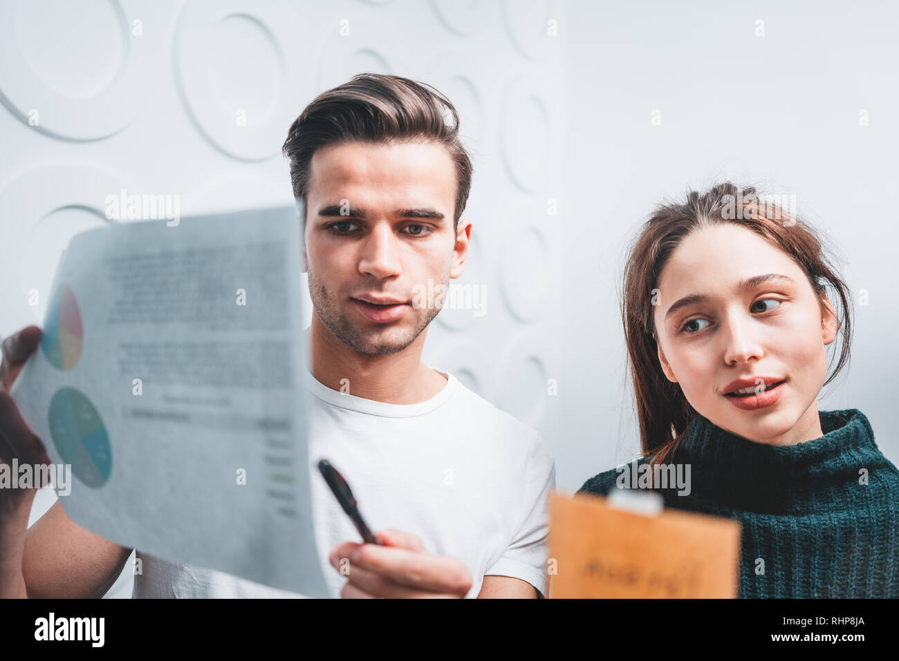 Portrait of coworker people standing at office space behind glass wall with sticky notes. Team of manager disscusing and brainstorming new sturtup ide Stock Photo