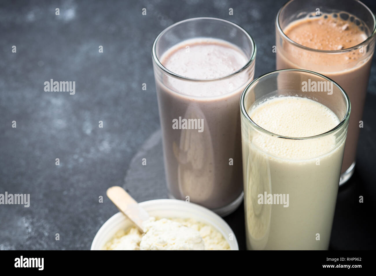 Protein cocktails on black. Vanilla, berry and chocolate protein shakes. Sports nutrition. Stock Photo