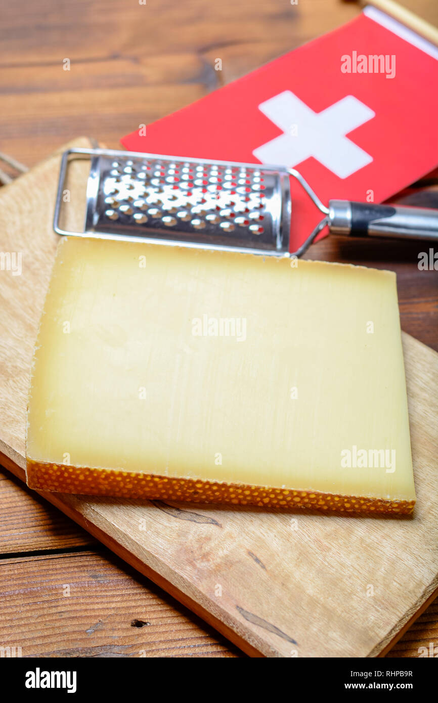 Block of Swiss hard cheese Le Gruyere used for traditional fondue and gratin, closeup Stock