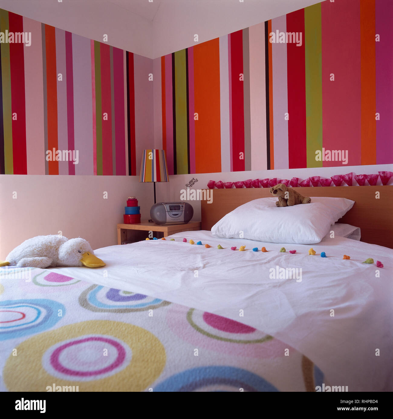 Colourful Striped Wallpaper In Modern Bedroom Stock Photo