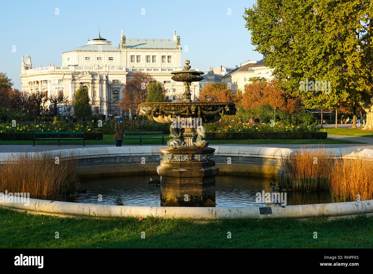 Fountain in Volksgarten Park and Garden and Burgtheater (Austrian National Theatre), Vienna, Austria Stock Photo