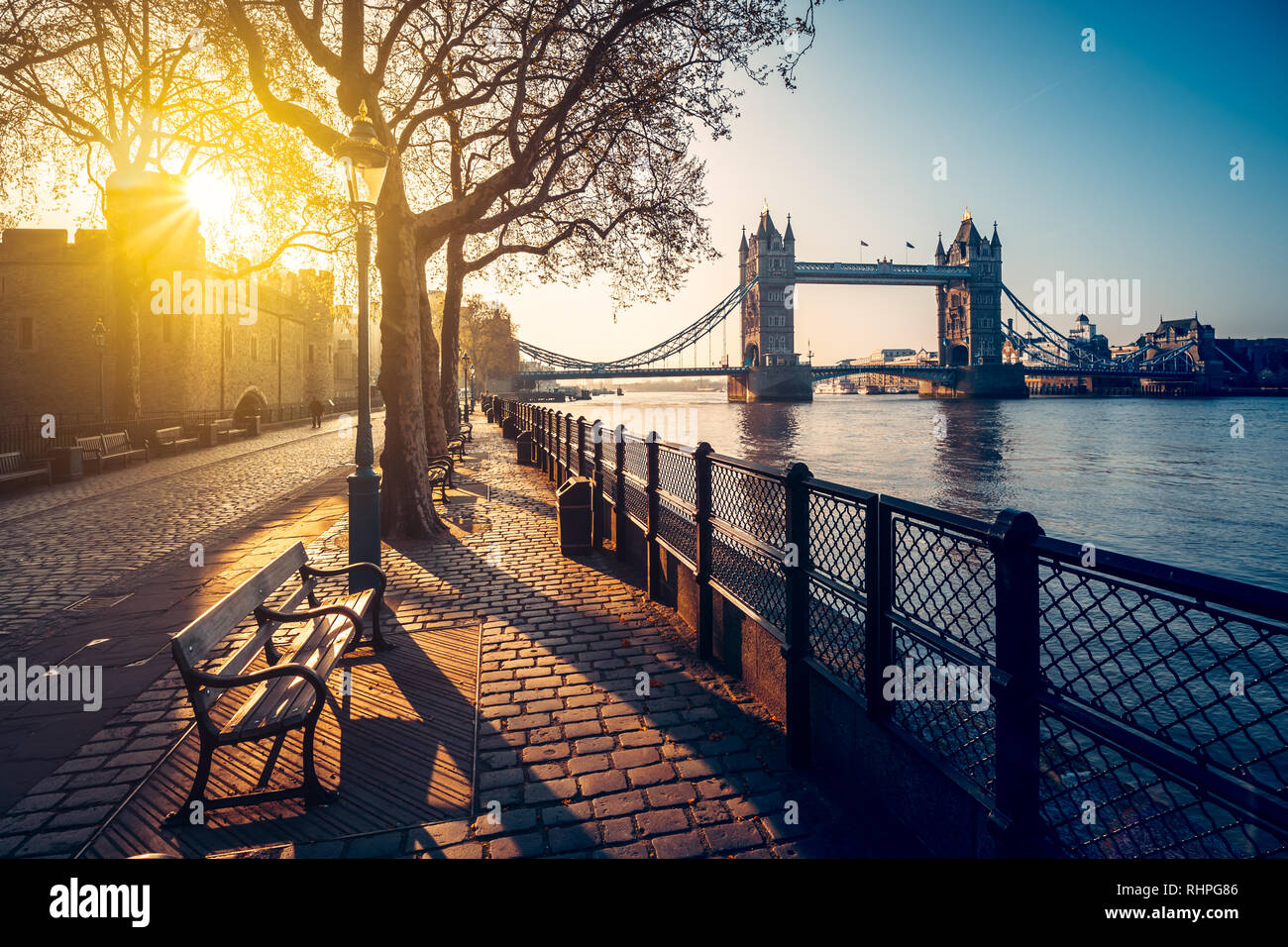 A boulevard next to the river Thames with Tower Bridge in the distance Stock Photo