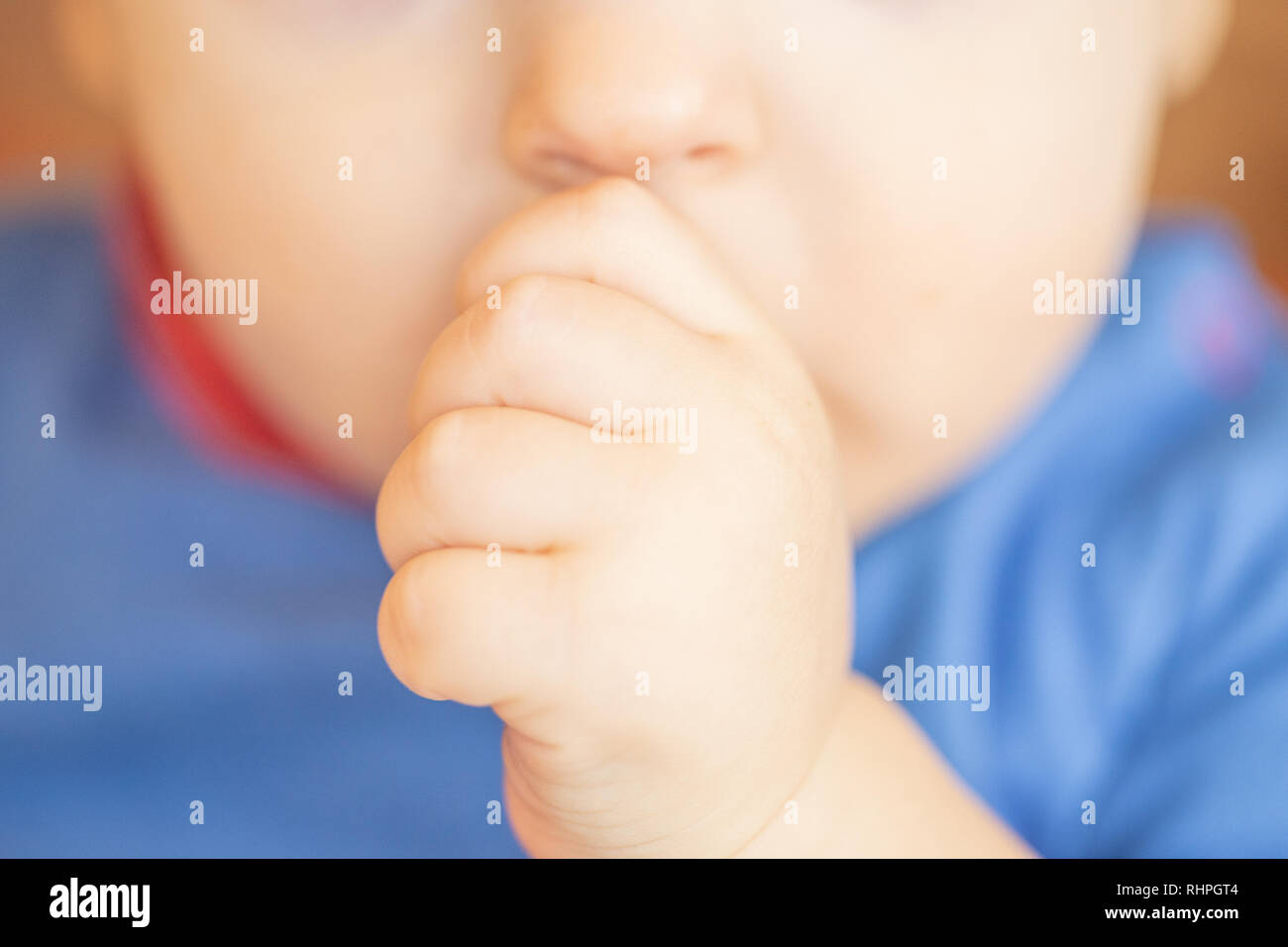 Young baby sucking his thumb Stock Photo