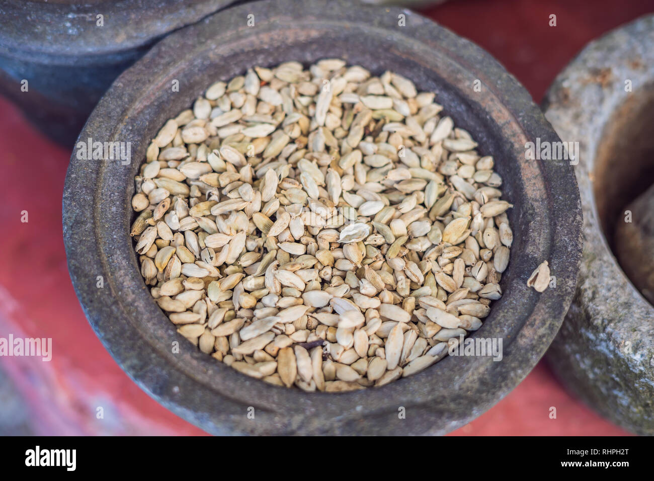 Pods of green cardamom in a large pottery Stock Photo
