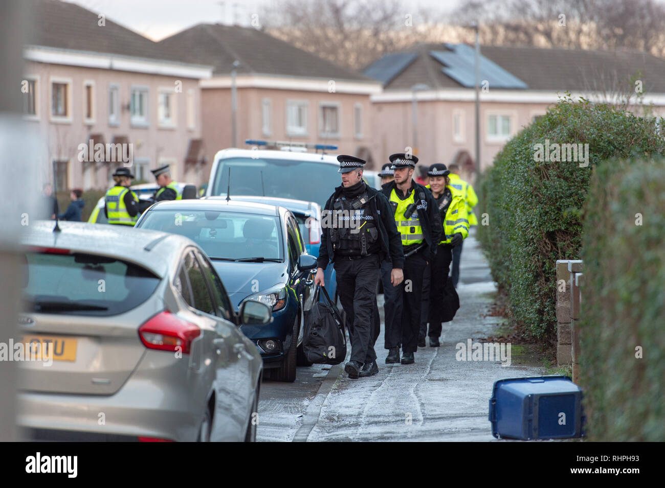 Armed police and Dog units outside a flat on Stenhouse Street West, Edinburgh Stock Photo