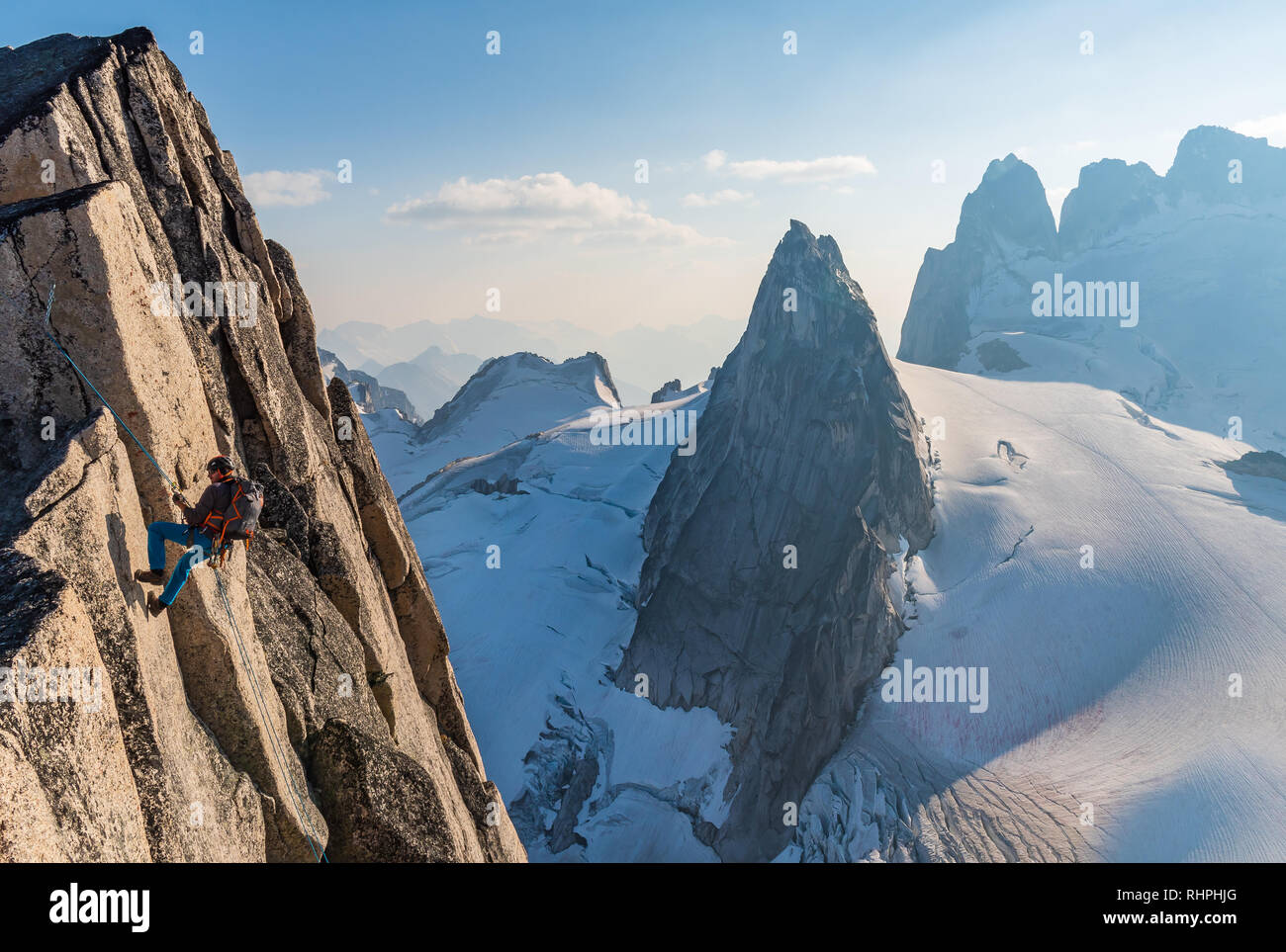 Brandon Prince descends a route called Surfs Up rated 5.9 on Snowpatch Spire in the Bugaboos Stock Photo
