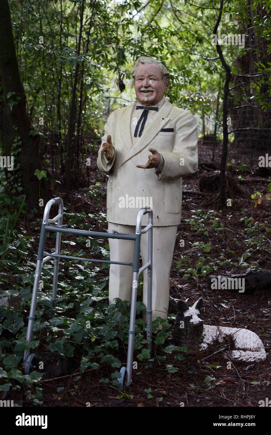 A decaying old statue of Colonel Sanders. Stock Photo