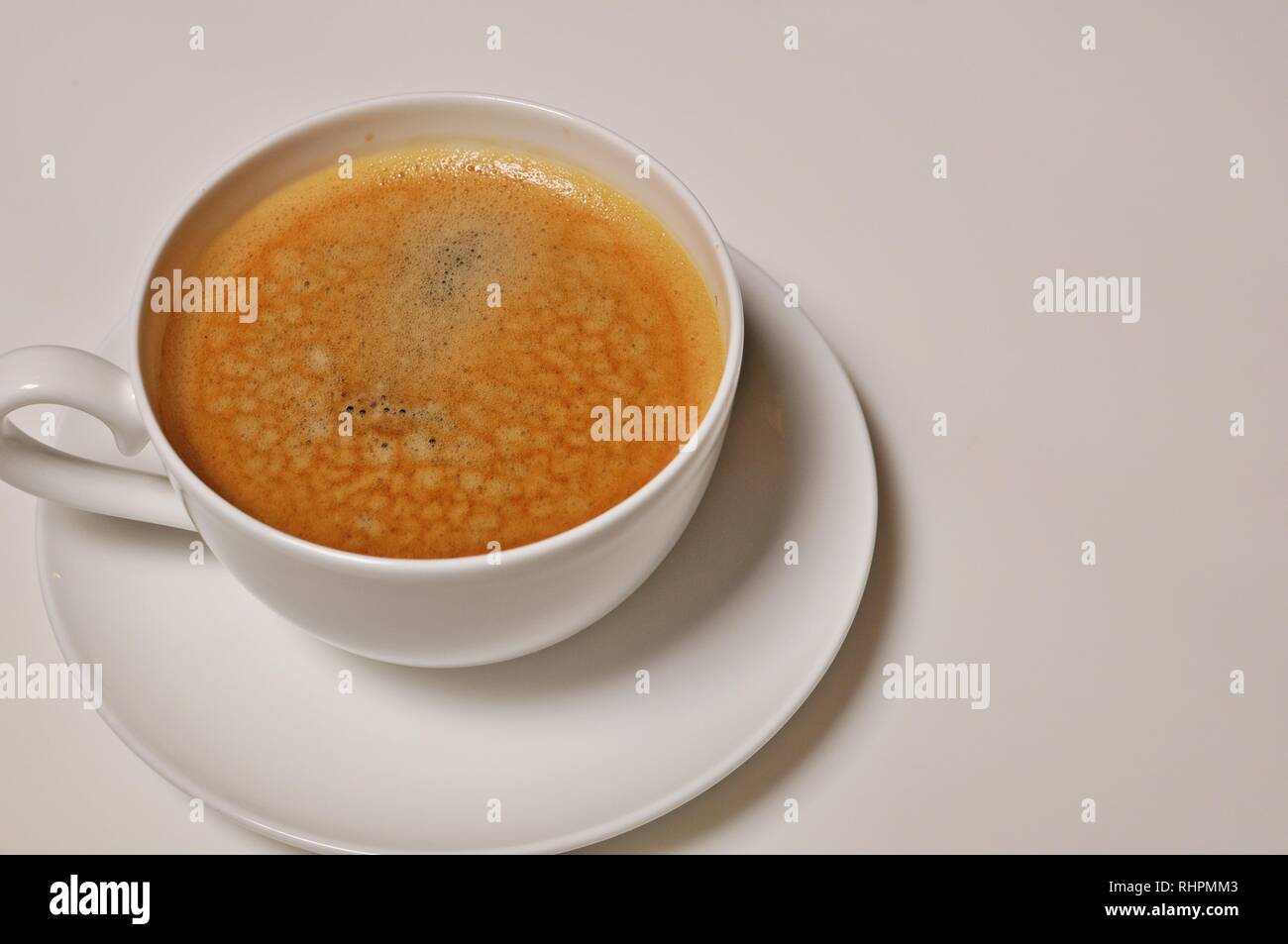 Close up of a hot cup of coffee on white background with copy text Stock Photo