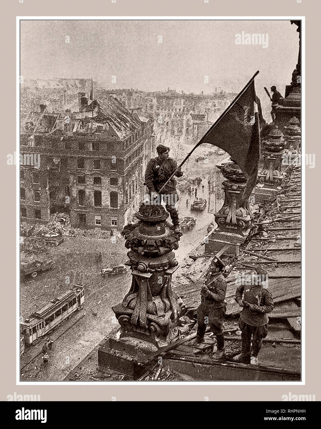 RUSSIAN FLAG BERLIN 1945 REICHSTAG ICONIC World War 2 Germany. Russian soldier raising Soviet Hammer and Sickle flag over the Nazi Reichstag Chancellory Russian Flag, a historic World War II photograph, taken during the Battle of Berlin on 2 May 1945. It shows Soviet Union Troops Meliton Kantaria and Mikhail Yegorov raising their flag over the former Nazi seat of power, the Berlin Reichstag Berlin Germany Stock Photo
