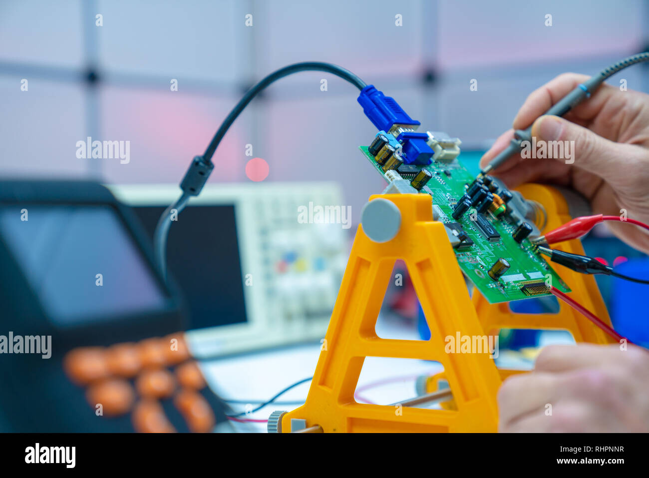 Fixing electronics PCB board in service /  workbench with electronics measuring instruments Stock Photo