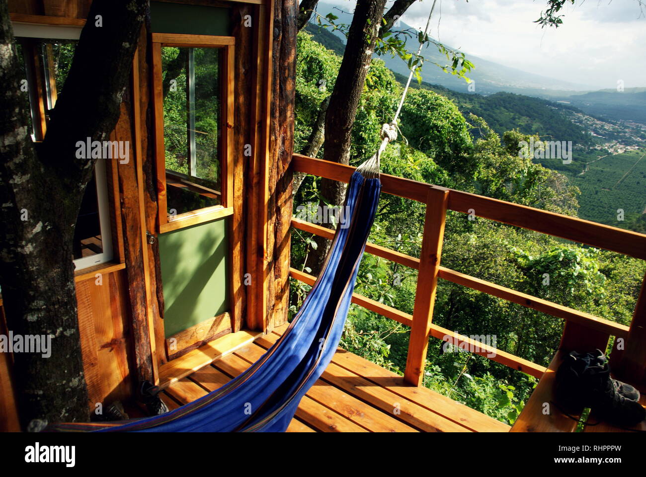 Relaxing in a hammock on the balcony of a tropical tree house in