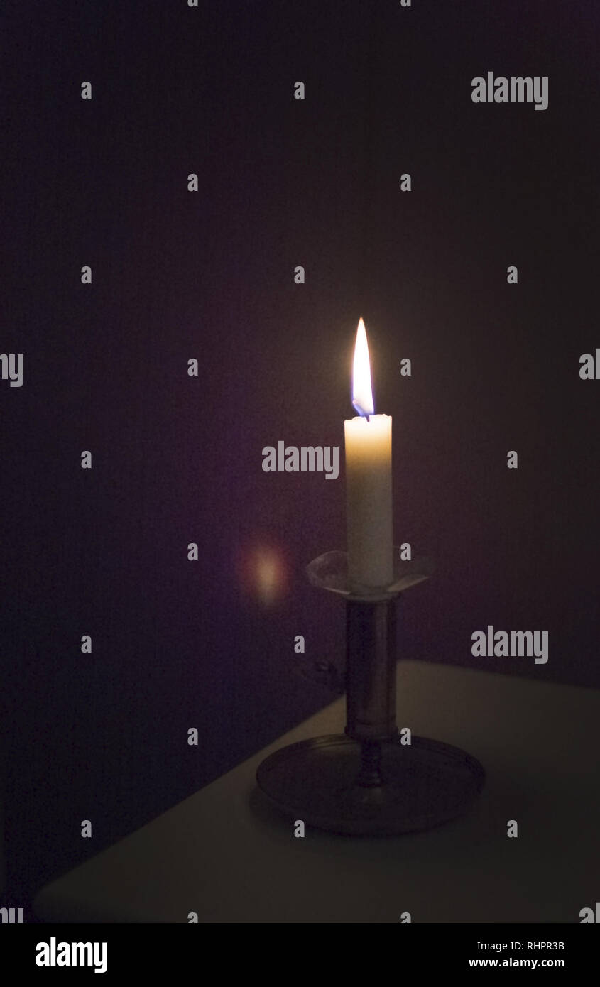 Simple candle burning in darkness, various concepts of darkness to
