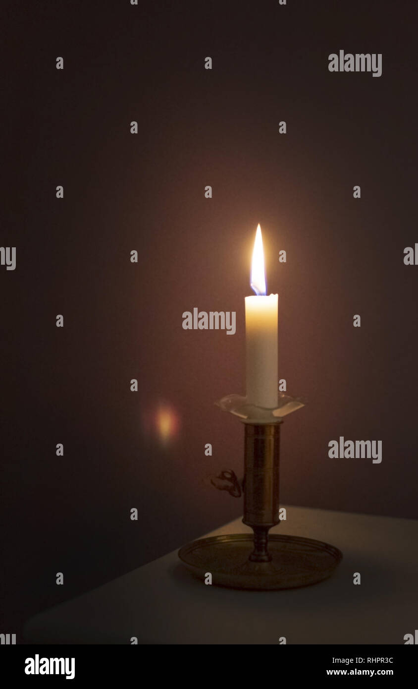Simple candle burning in darkness, various concepts of darkness to