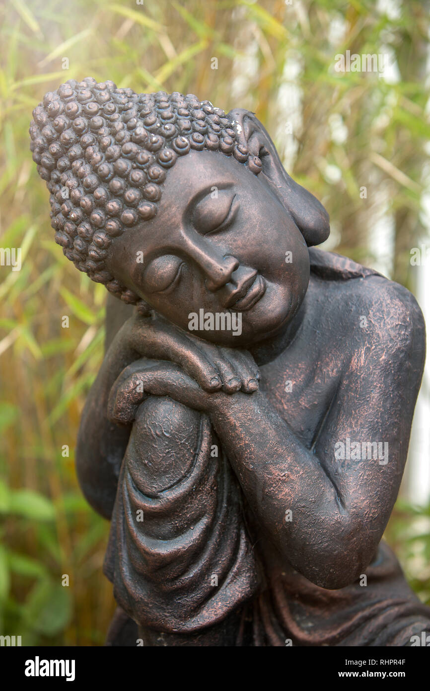 Sleeping Buddha statue in the garden Stock Photo - Alamy