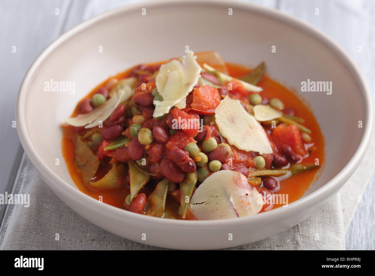 Three bean soup with Parmesan cheese and green pea Stock Photo