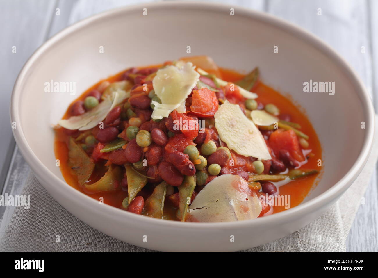 Three bean soup with Parmesan cheese and green pea Stock Photo