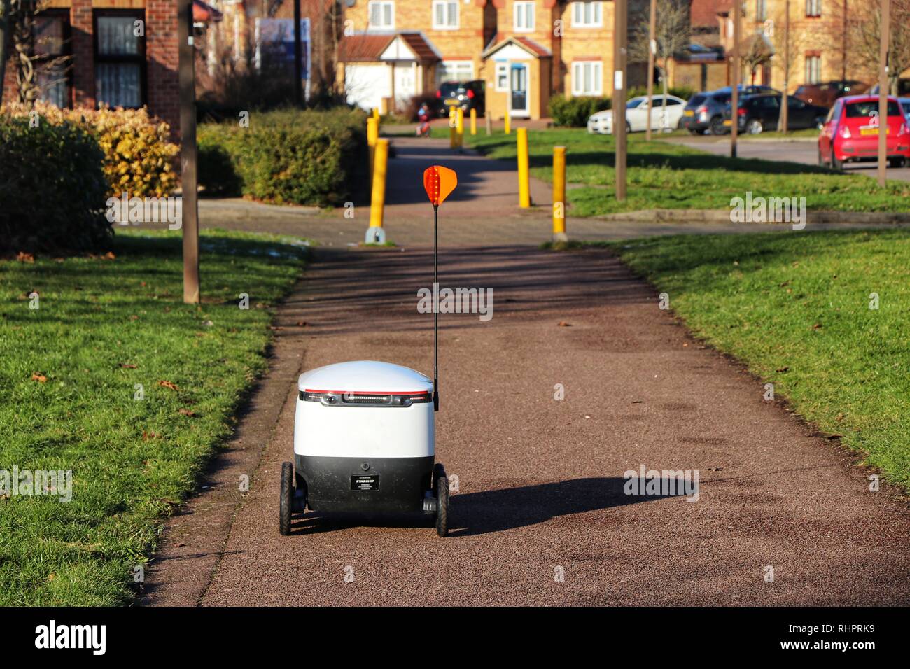 Pedestrians go about their daily lives as Starship Technologies autonomous robots make routine grocery deliveries around Milton Keynes. Stock Photo
