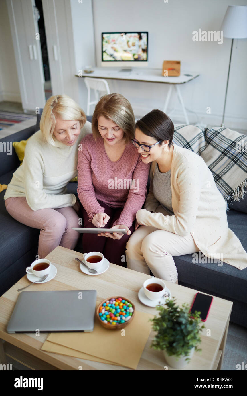 Three Women Using Digital Tablet Stock Photo