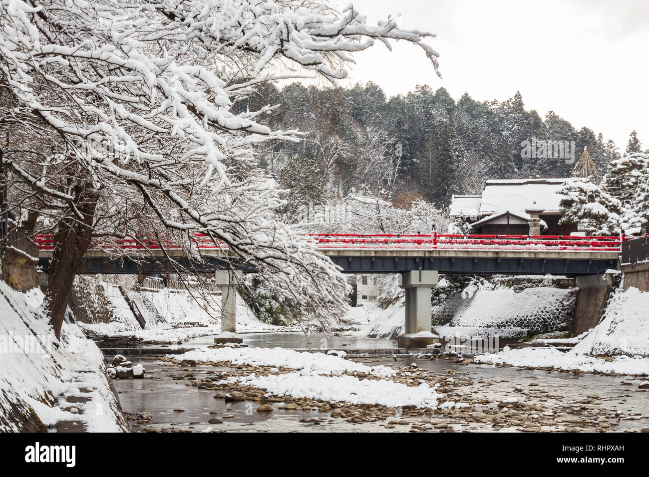 Nakabashi Bridge with snow fall and Miyakawa river in winter season . Landmark of Hida , Gifu , Takayama , Japan . Landscape view . Stock Photo