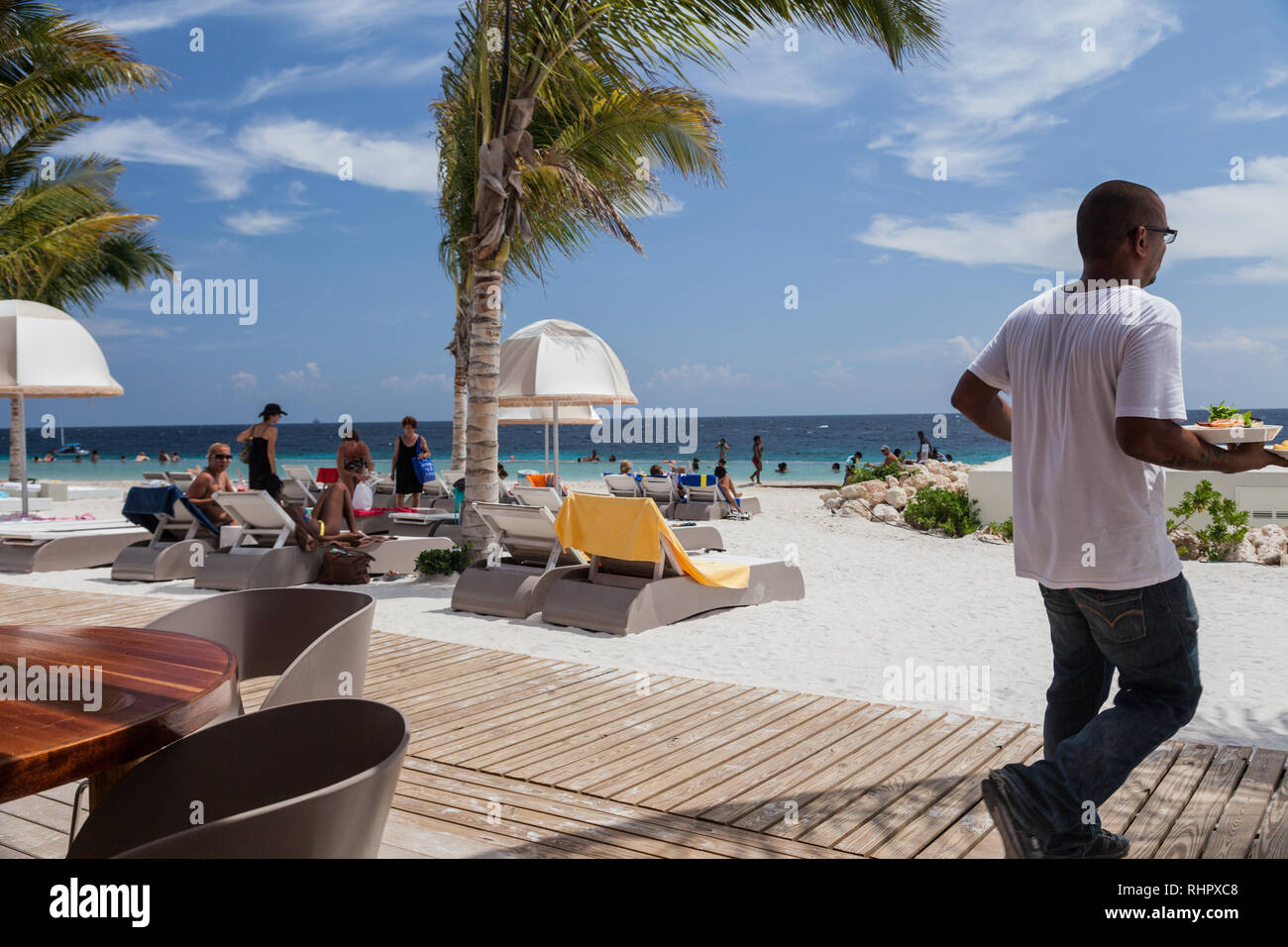 Waiter carrying food at beach Stock Photo