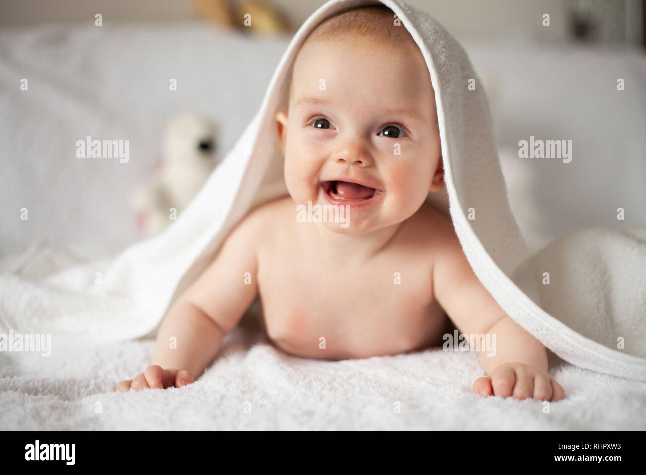 baby girl is hiding under the white blanket Stock Photo Alamy