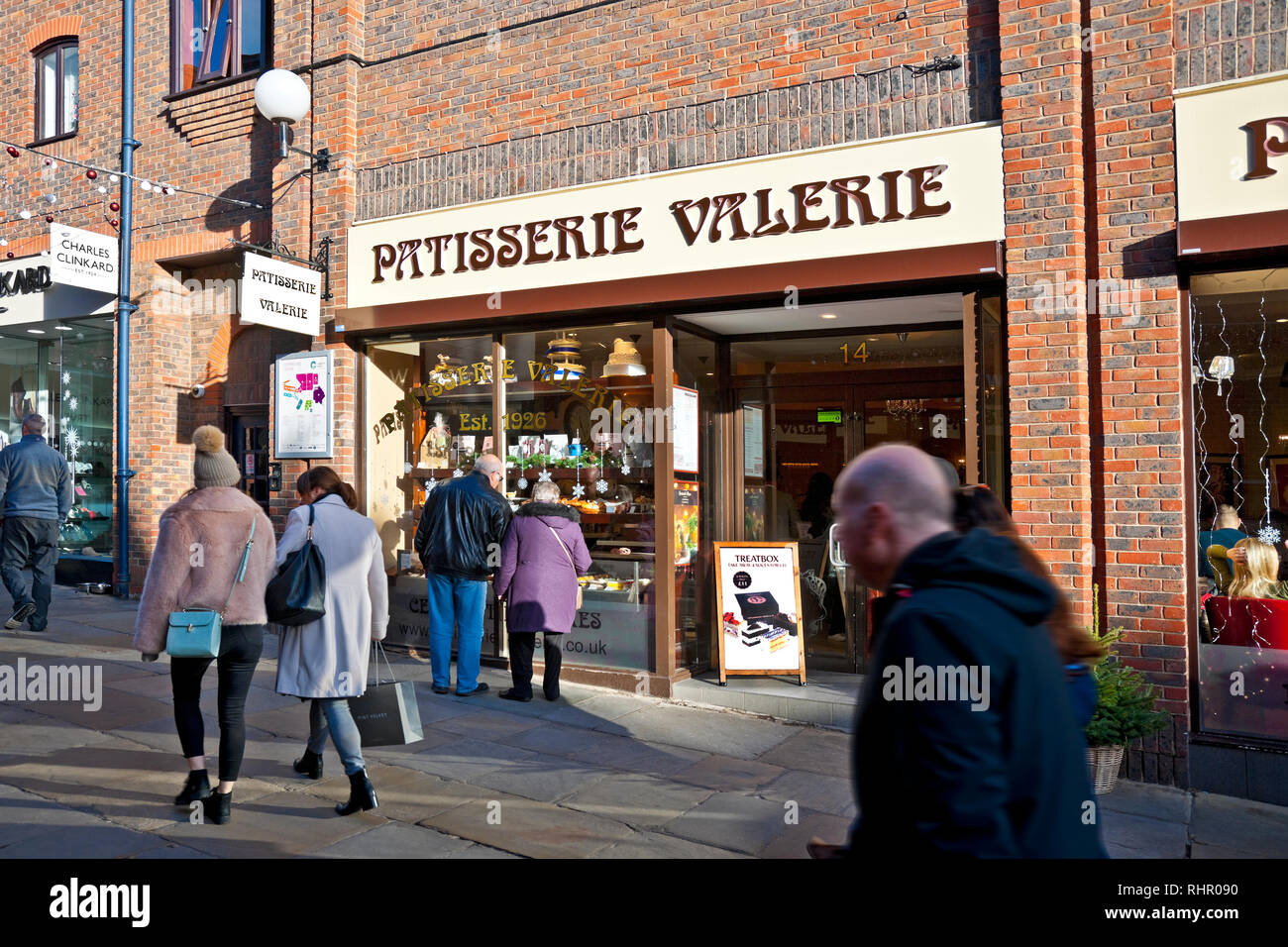 Couple people looking at Patisserie Valerie cafe restaurant shop store