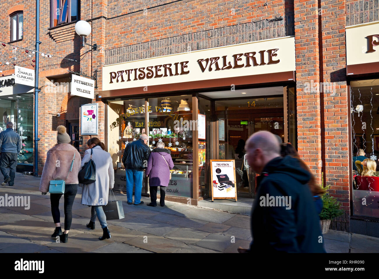 Couple people looking at Patisserie Valerie cafe restaurant shop store window display exterior York North Yorkshire England UK United Kingdom Stock Photo