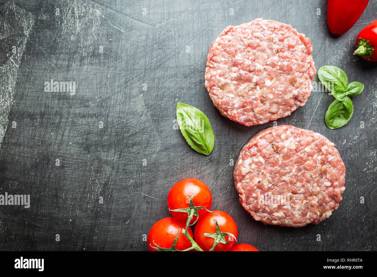 Fresh raw Prime Black Angus beef burger patties on black background. Top view Stock Photo Alamy