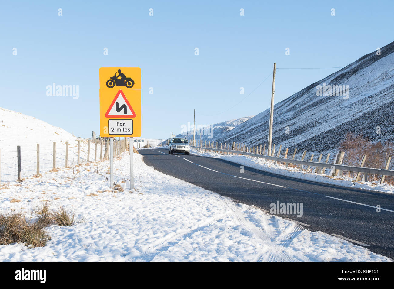 Dangerous bends road sign on the A93 (Old Military Road) in The Cairngorms leading up to Glenshee Ski Centre, Scotland, UK Stock Photo