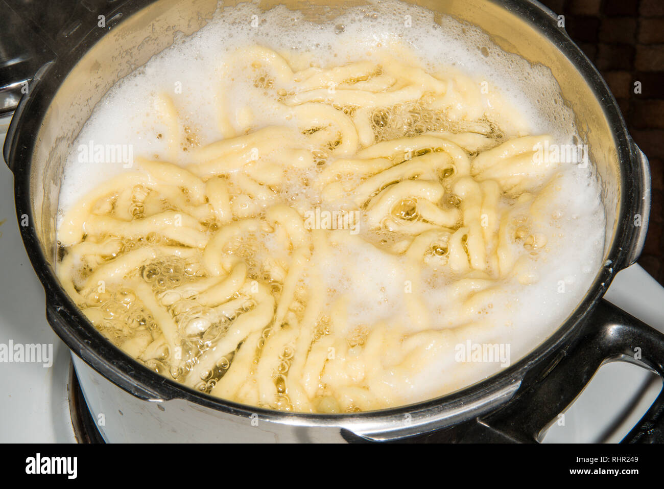 German noodles called Spaetzle cooking in a pot Stock Photo Alamy