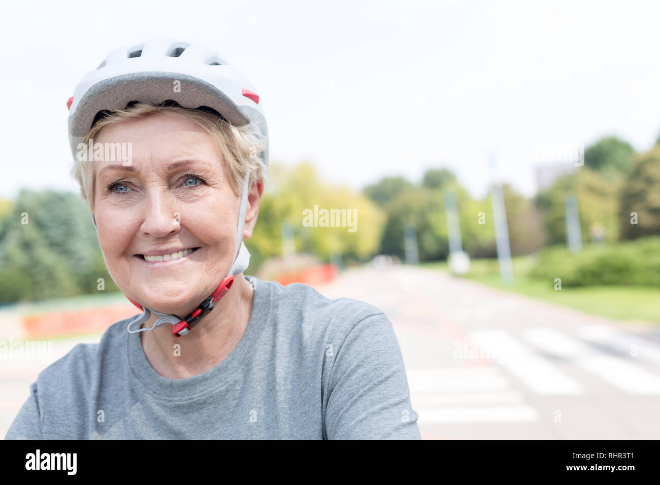Woman cycling wearing helmet park hi-res stock photography and images ...