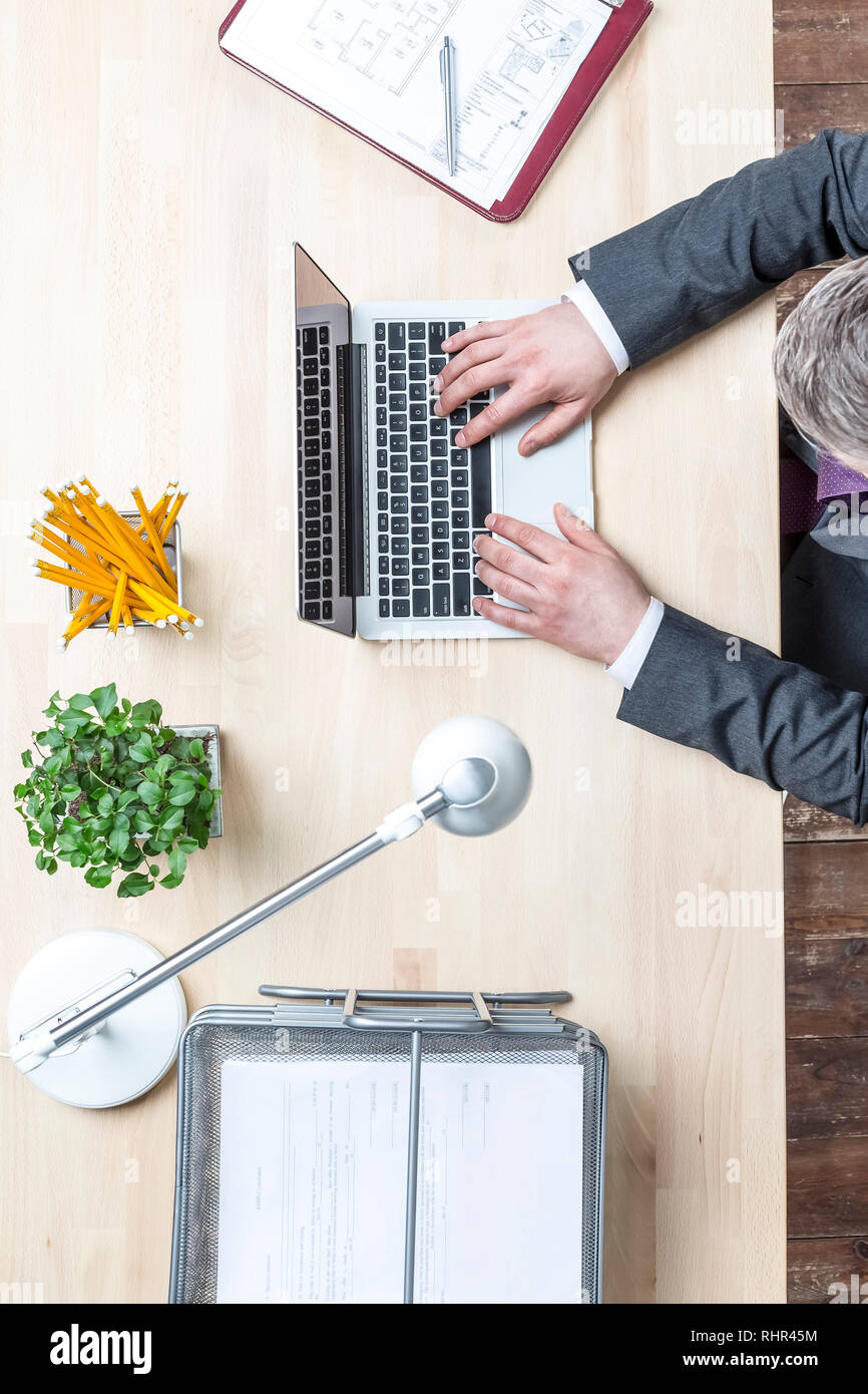 Directly above view of mature businessman using laptop at office Stock Photo