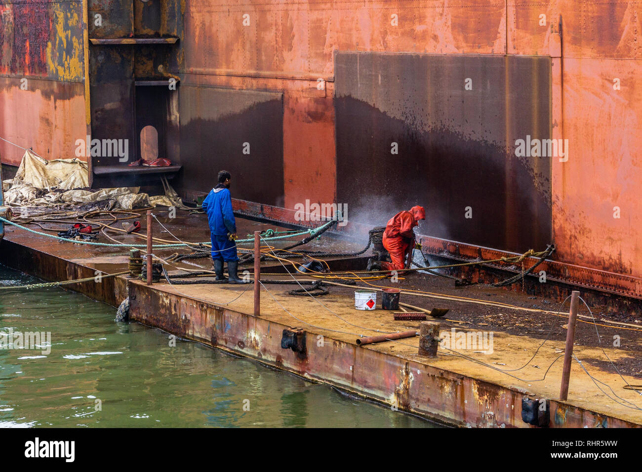 ship cleaning by jet water Work in floating dry dock the shipboard of the ship from sea