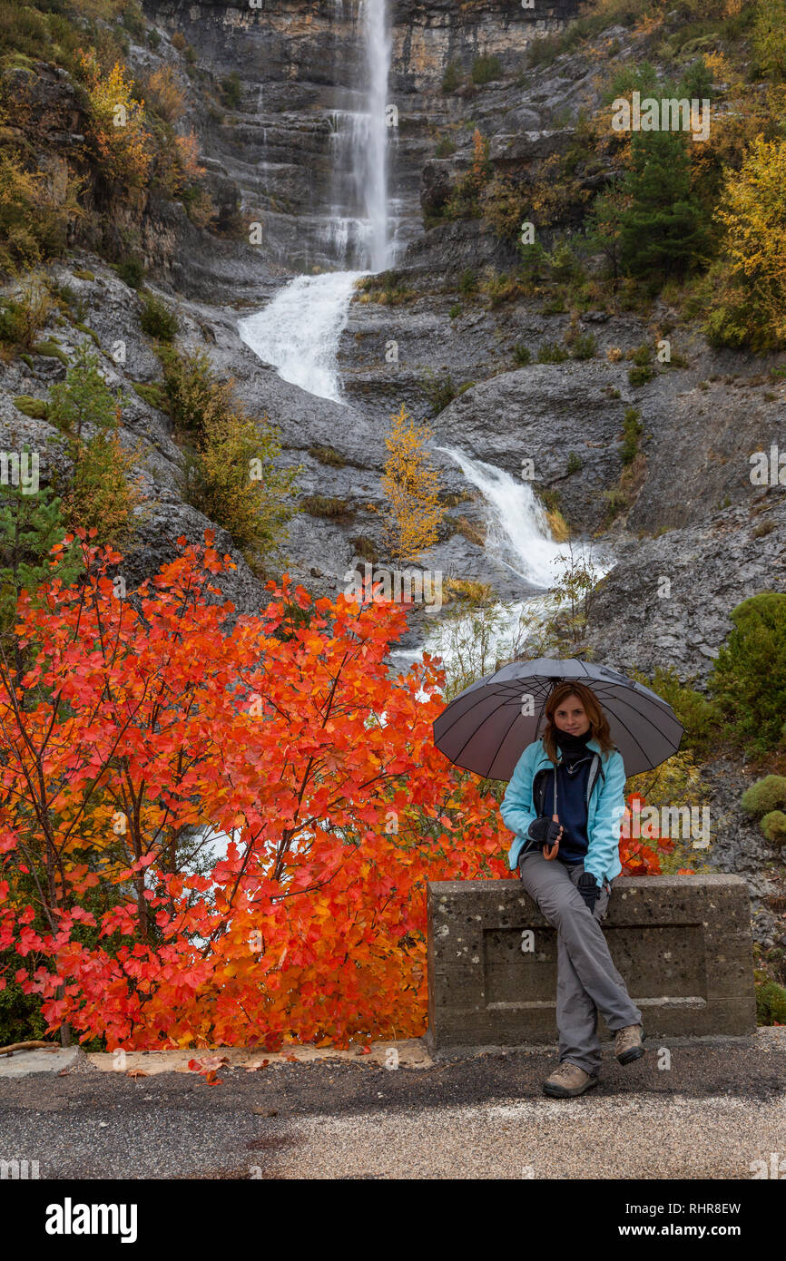 A girl with an umbrella in autumn at Ordesa National Park, Huesca, Aragon, Spain, Europe Stock Photo