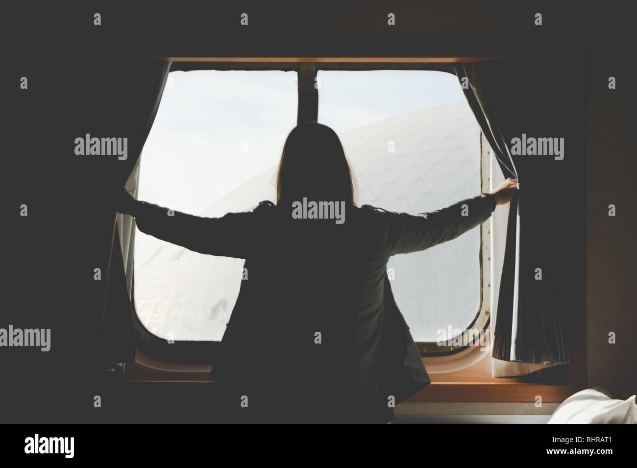 Pretty Woman Viewed From The Back Excitedly Opening Curtains Of