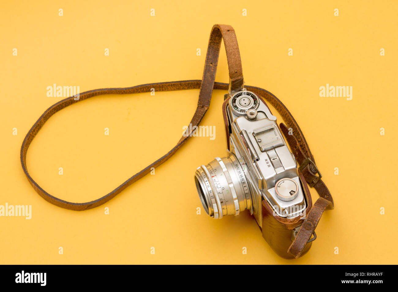 Vintage Camera with A Leather Strap Hanging on Yellow Stock Photo - Alamy