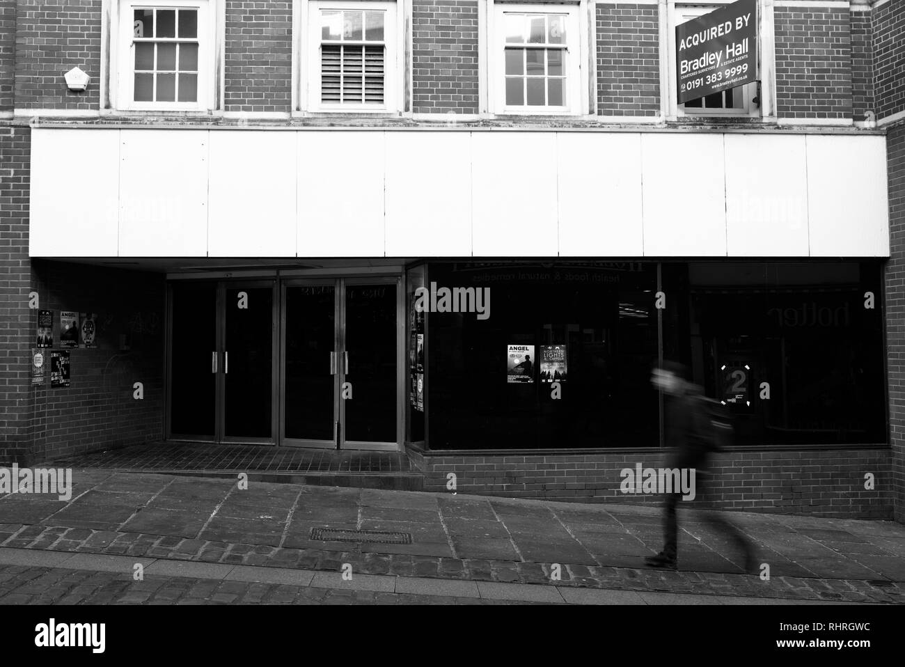 A blurred shopper walks by the now empty Marks and Spencer in Durham ...