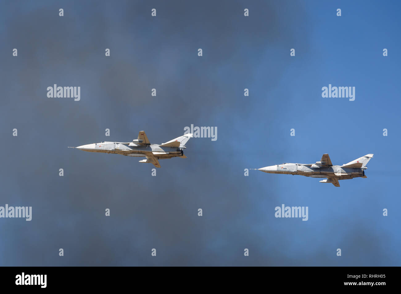 International military technical forum ARMY-2018. A pair of SU-24 aircraft perform demonstration flights in the sky over a military training ground Stock Photo