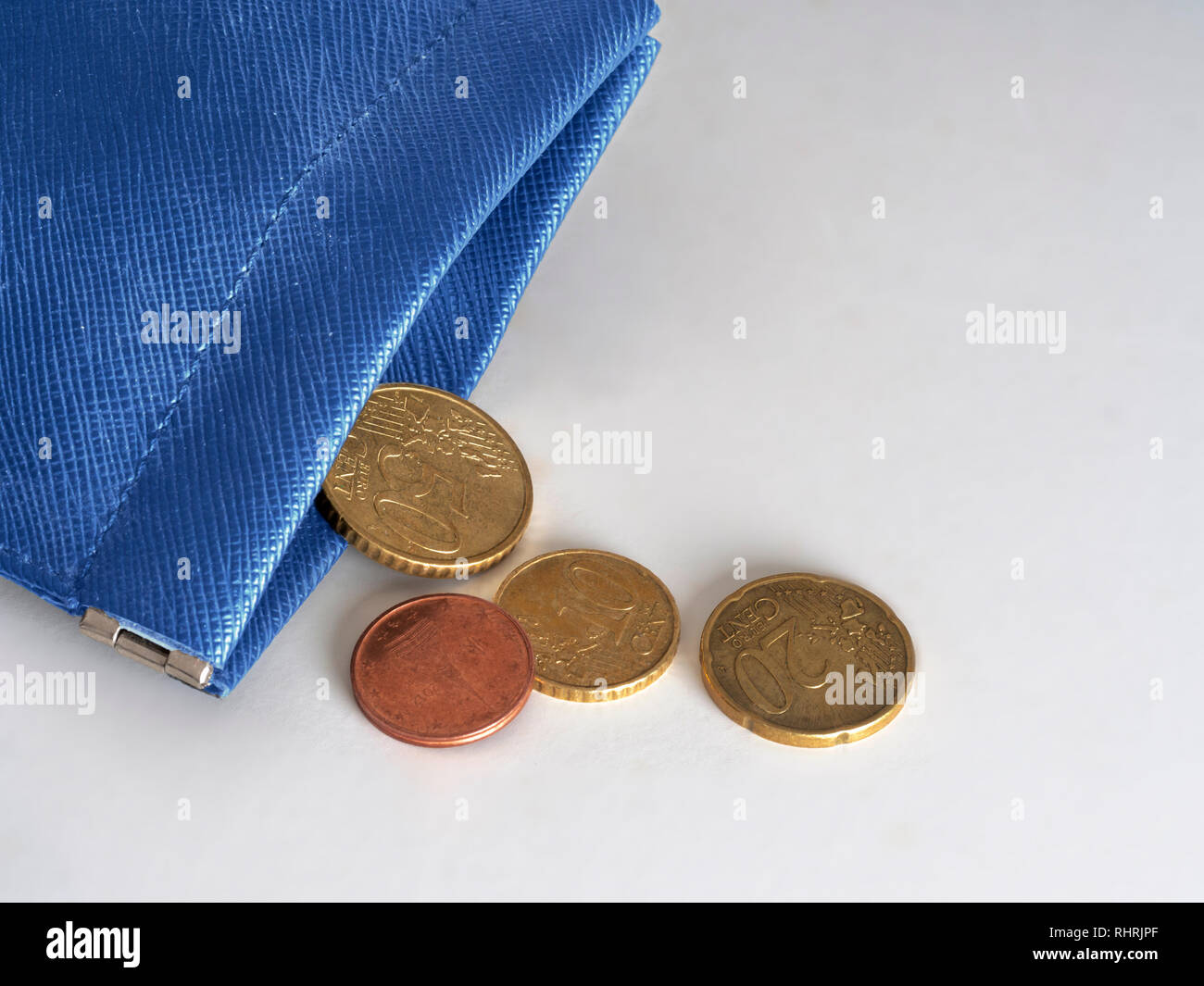 Blue purse almost empty, running out of money, euros. Financial, banking crisis, EU, Europe, Italy etc or poverty in the Union. Concept, metaphor. Stock Photo