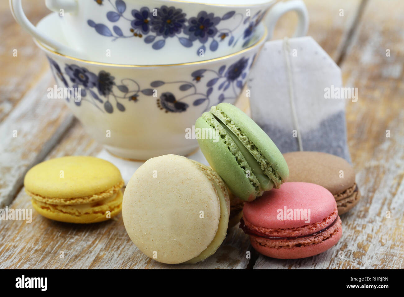 Stack of colorful crunchy macaroons on rustic wooden surface Stock Photo