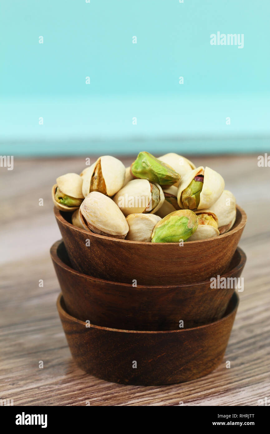 Pistachio nuts in wooden bowl with copy space Stock Photo Alamy