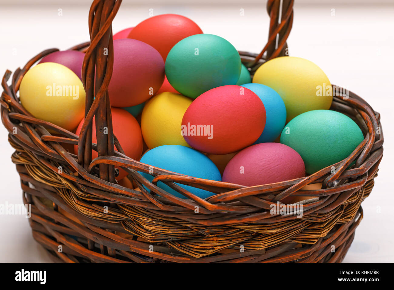 Many Easter colored eggs in the basket. Close-up Stock Photo