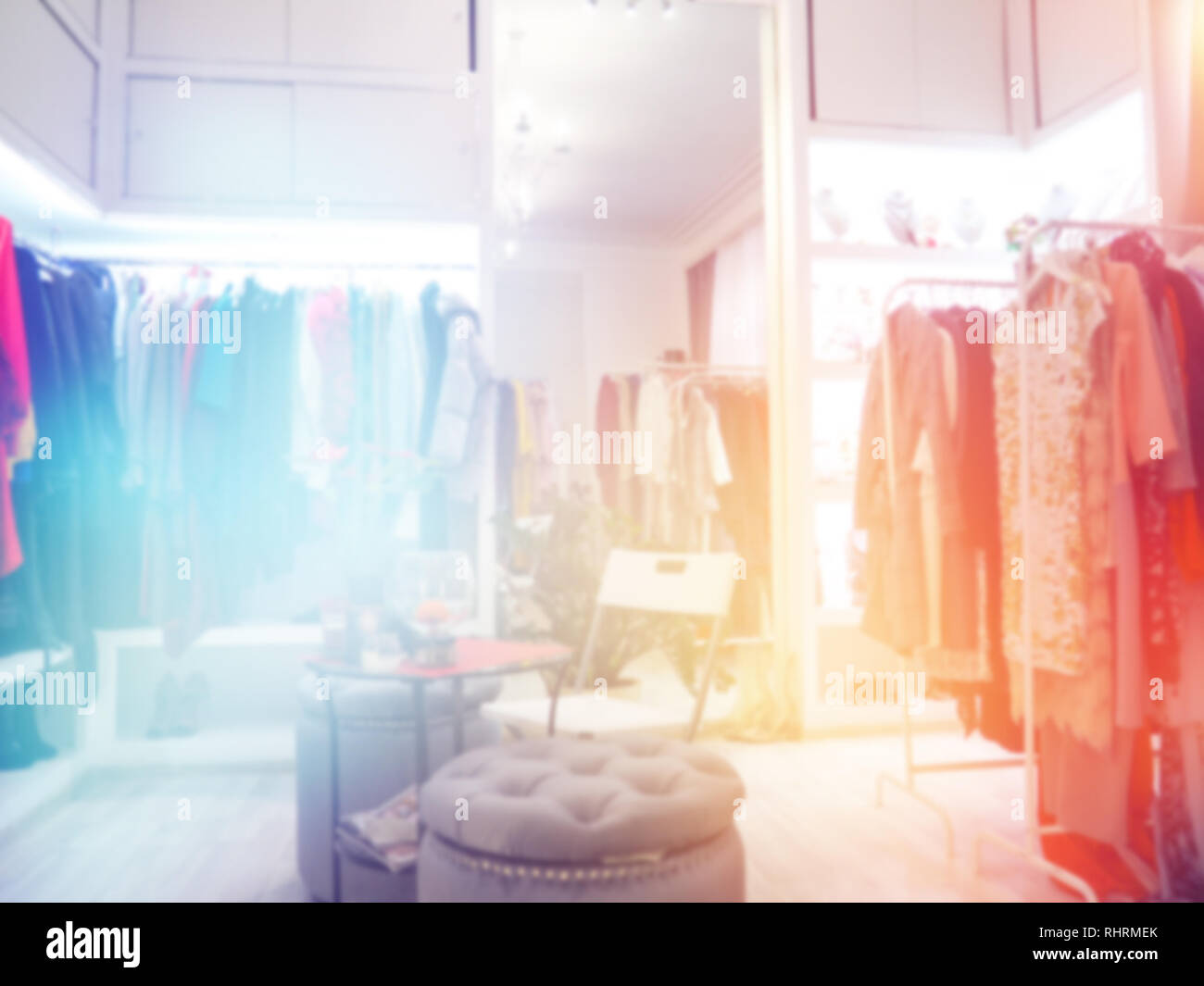 blurred clothes on hanger in clothing store. Abstract blur and defocused shopping mall of department store interior for background. Stock Photo