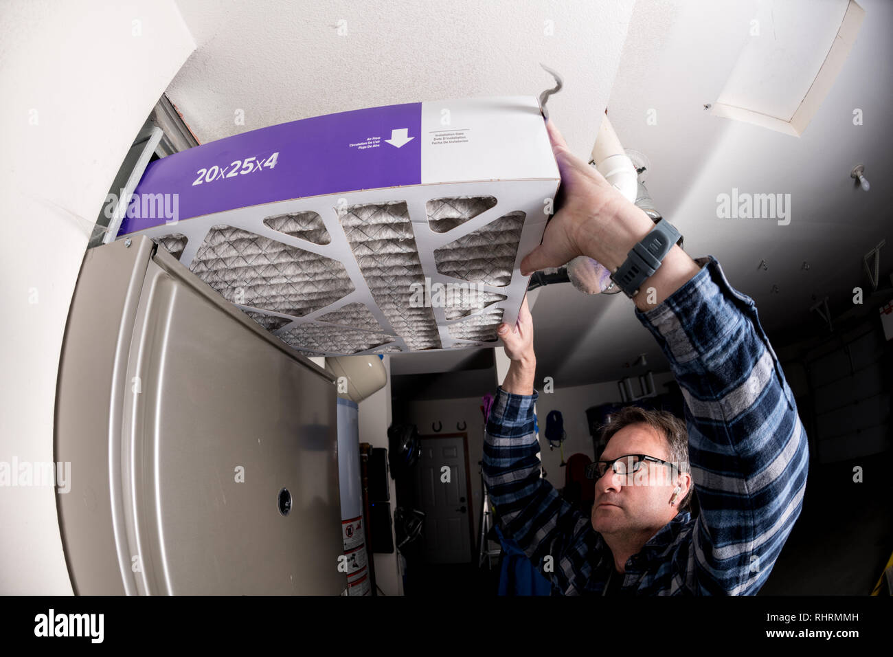 Thick furnace filter demonstration by a handyman Stock Photo Alamy