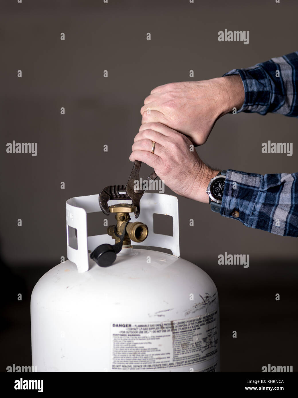 Pliers clamped onto a brass knob on the top of a propane tanks Stock Photo Alamy