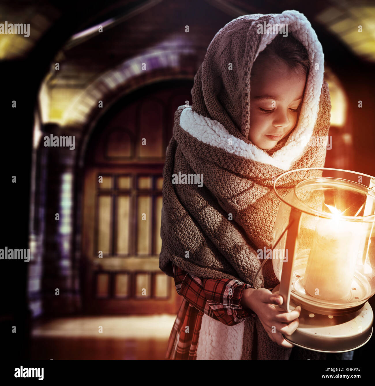 Conceptual portrait of a cute, little girl holding a torch Stock Photo