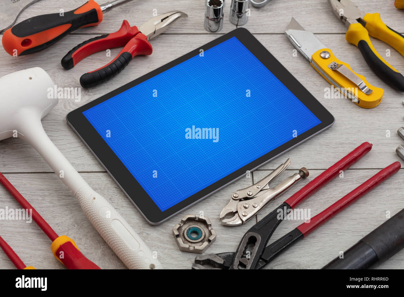 Household tools and tablet with grid screen concept Stock Photo