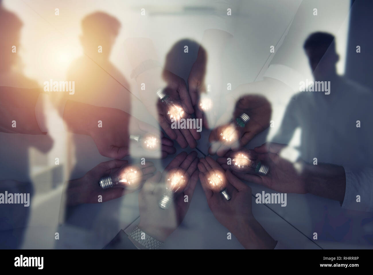 Teamwork and brainstorming concept with businessmen that share an idea with a lamp. Concept of startup. Double exposure Stock Photo