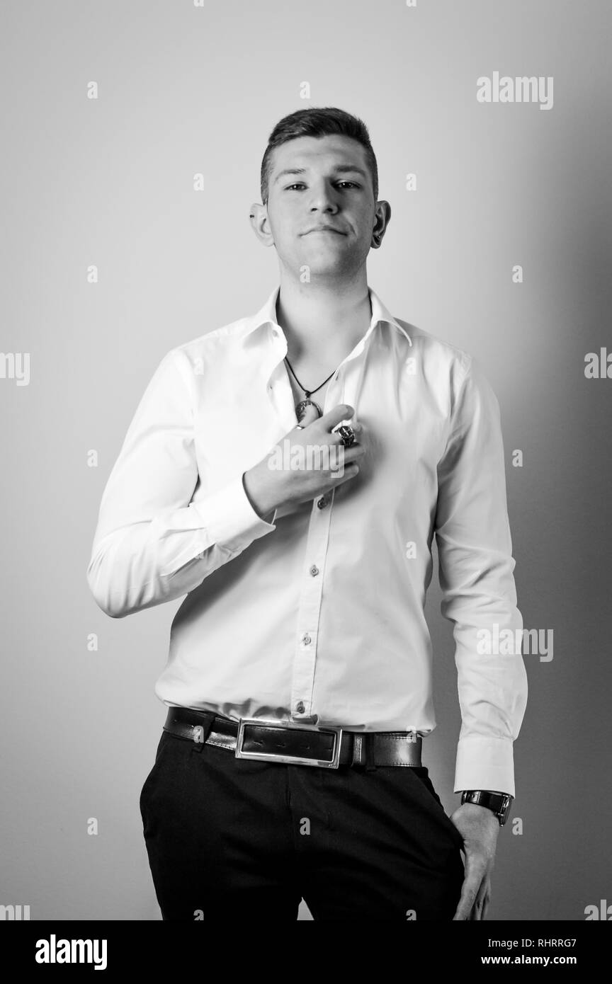 Portrait of confident young man in white shirt Stock Photo - Alamy