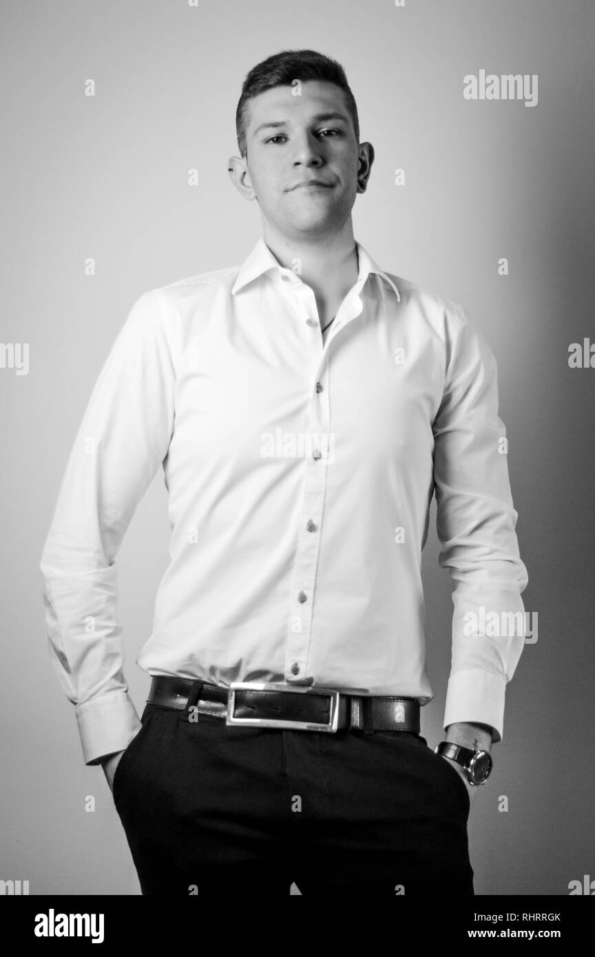 Portrait of confident young man in white shirt Stock Photo - Alamy